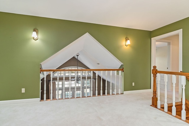 additional living space featuring vaulted ceiling, carpet floors, and baseboards