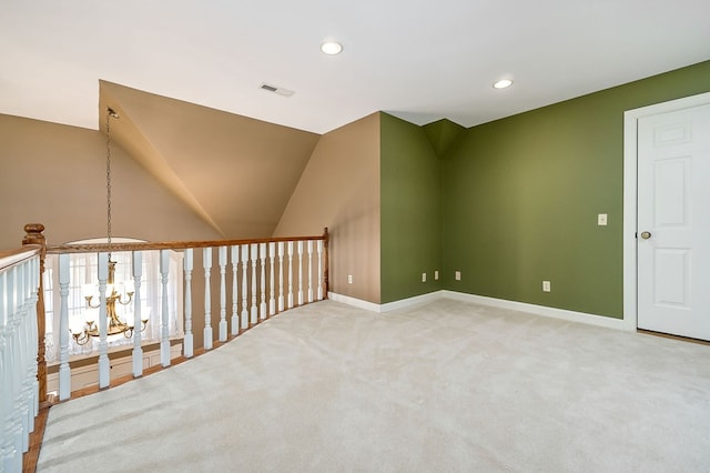 unfurnished room featuring visible vents, lofted ceiling, carpet floors, a chandelier, and recessed lighting