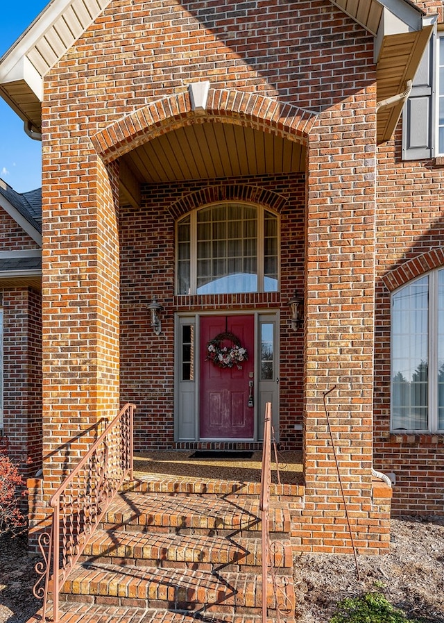 view of exterior entry with brick siding