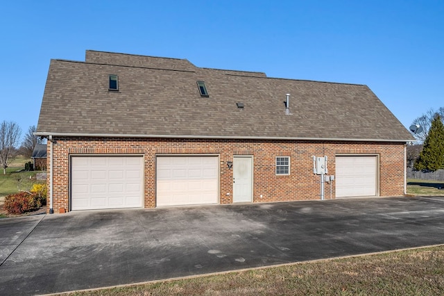 view of side of home with brick siding and roof with shingles