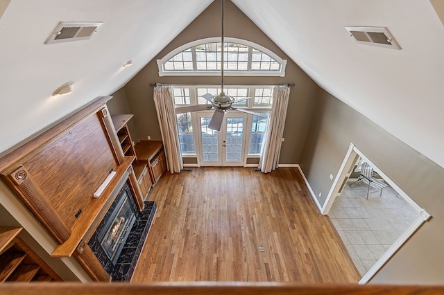 foyer featuring vaulted ceiling, french doors, wood finished floors, and visible vents