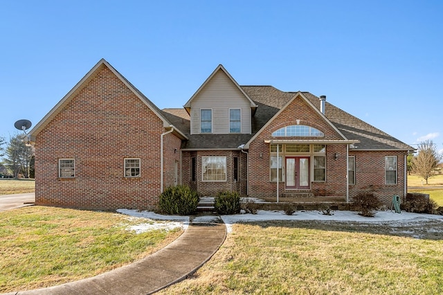 view of front of house featuring a front lawn, french doors, and brick siding