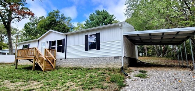 exterior space featuring a carport, crawl space, driveway, and stairway