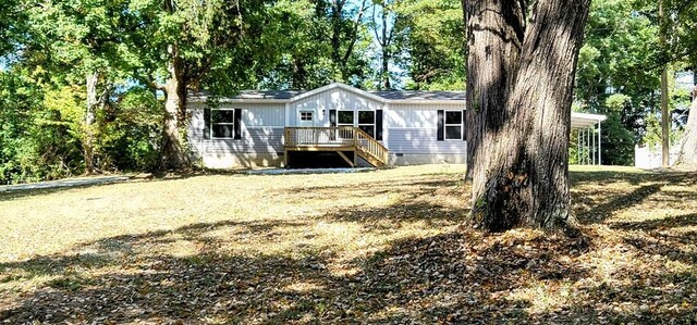 back of house featuring crawl space, stairway, a lawn, and a wooden deck