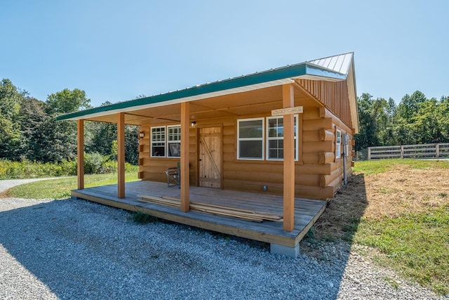 view of outbuilding with fence and an outbuilding