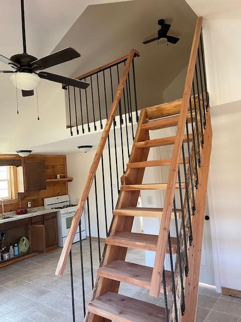 stairway with a ceiling fan