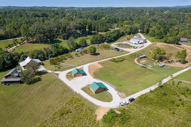 birds eye view of property with a forest view