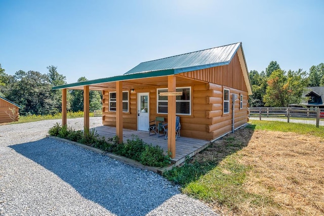 view of outbuilding featuring driveway and fence