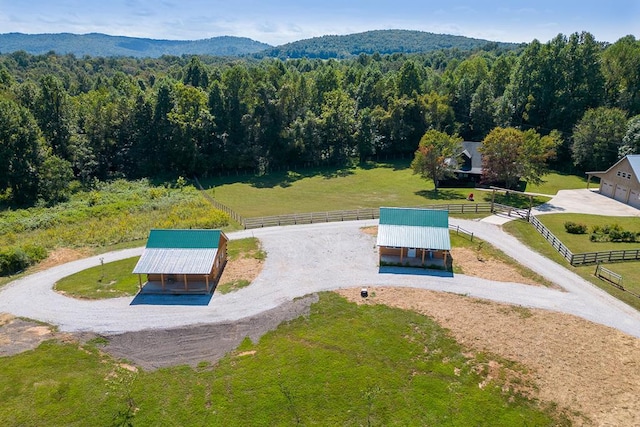 drone / aerial view with a rural view, a wooded view, and a mountain view