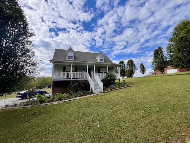 view of front facade featuring covered porch and a front lawn