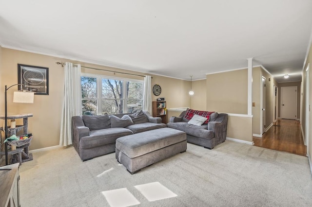 living room with carpet floors, ornamental molding, and baseboards