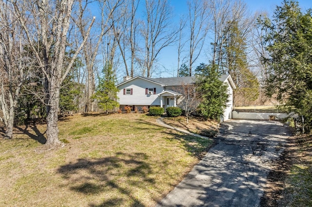 split level home with driveway and a front yard