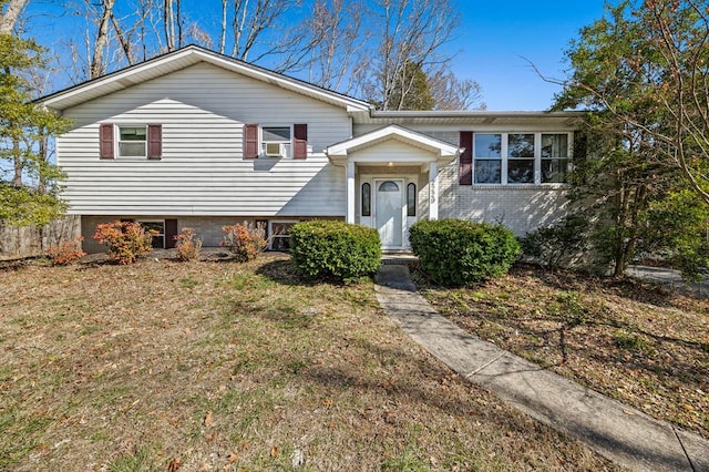 view of front of house with brick siding and a front lawn