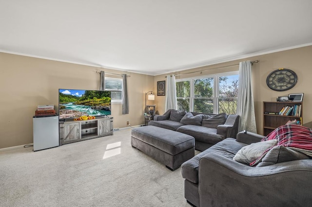 living area with ornamental molding, light carpet, and baseboards