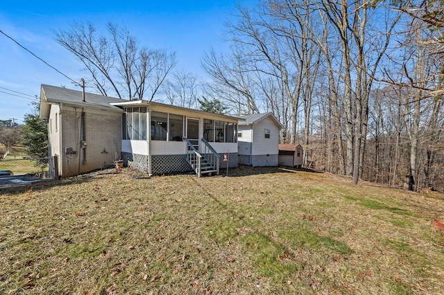 view of front facade featuring entry steps, a sunroom, a front yard, and brick siding