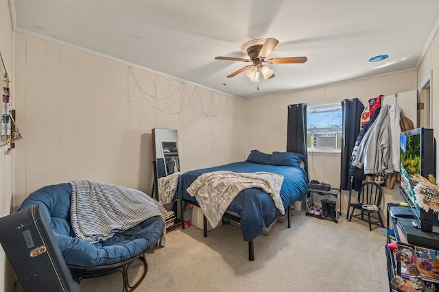 bedroom with ceiling fan, ornamental molding, and light colored carpet