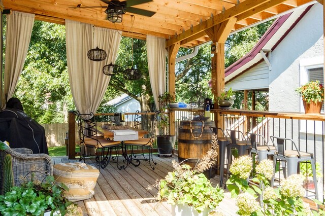 deck with ceiling fan, fence, and outdoor dining space