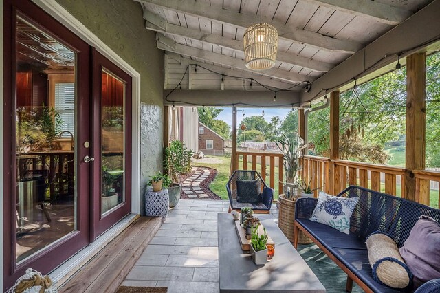 unfurnished sunroom with lofted ceiling with beams and wood ceiling