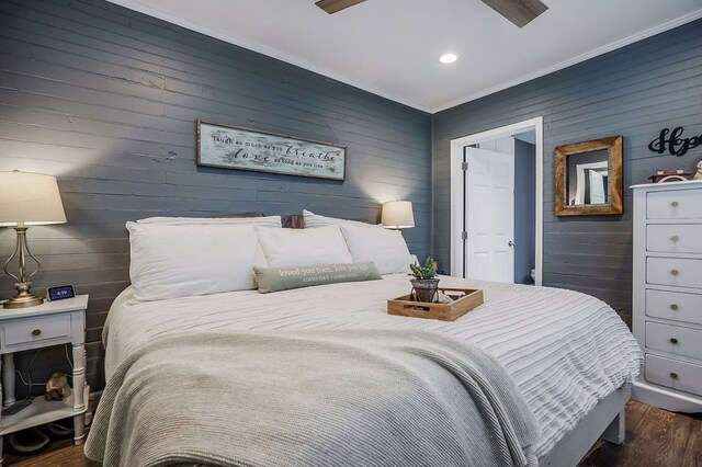 bedroom featuring ornamental molding and dark wood-style flooring