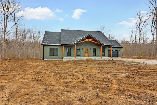 modern inspired farmhouse with a garage