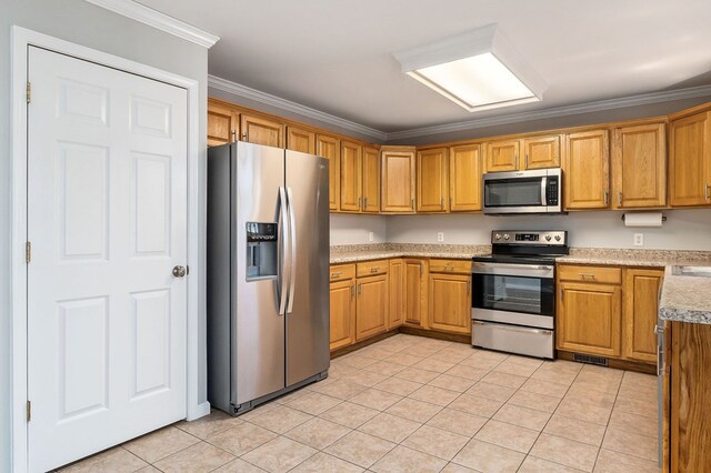 kitchen featuring light tile patterned floors, stainless steel appliances, visible vents, brown cabinetry, and ornamental molding