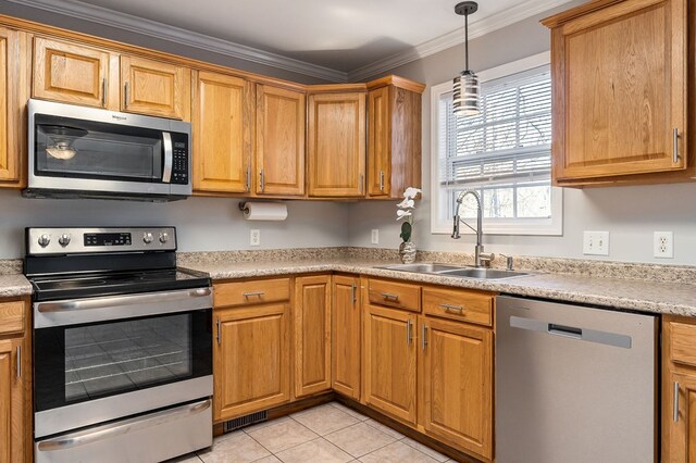 kitchen featuring light tile patterned floors, stainless steel appliances, crown molding, light countertops, and a sink