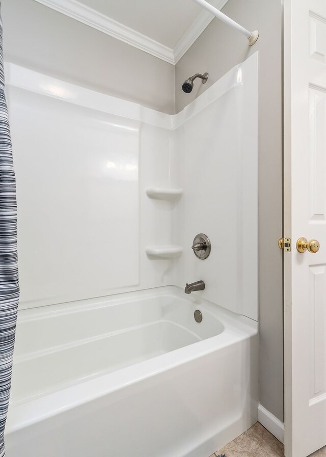 full bathroom featuring baseboards, shower / tub combo, tile patterned flooring, and crown molding