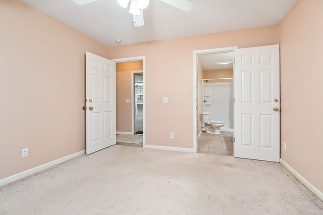 unfurnished bedroom with light carpet, a ceiling fan, and baseboards