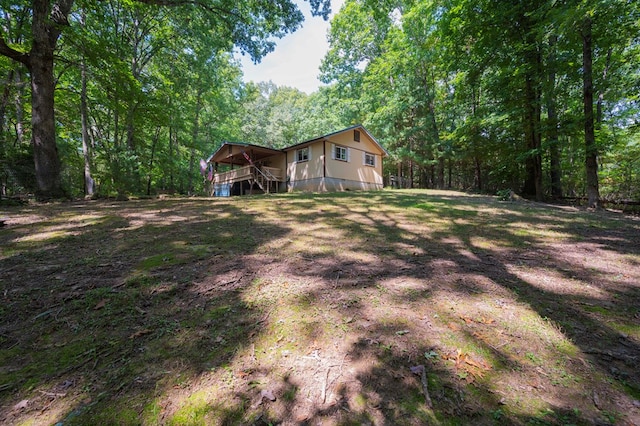 view of yard featuring stairs and a forest view