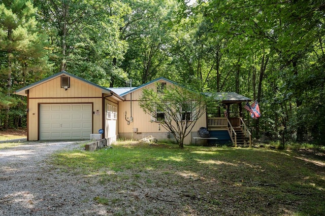 view of front facade featuring driveway, covered porch, and a garage