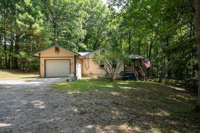 view of front of house with a garage and gravel driveway