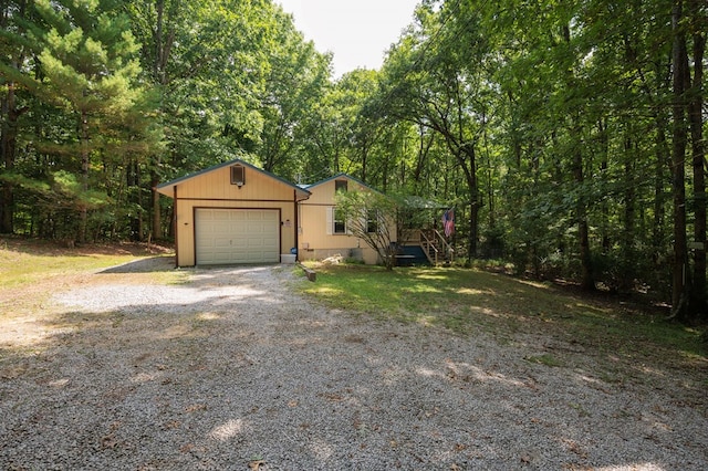 view of front of house with a garage and gravel driveway