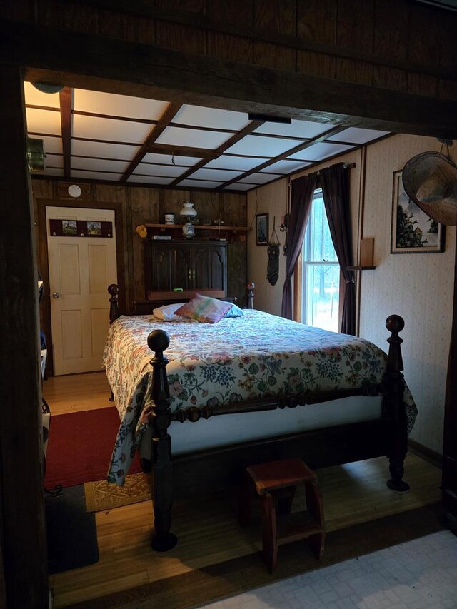 bedroom with light wood-style flooring and wallpapered walls