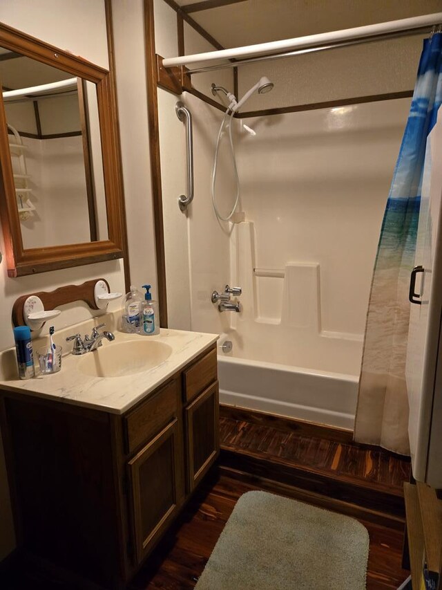 bathroom featuring vanity, shower / tub combo with curtain, and wood finished floors