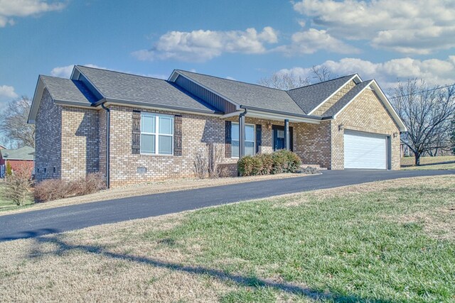 single story home featuring an attached garage, a shingled roof, aphalt driveway, and brick siding