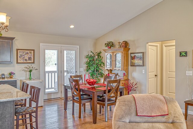 dining room with lofted ceiling, recessed lighting, and light wood-style floors