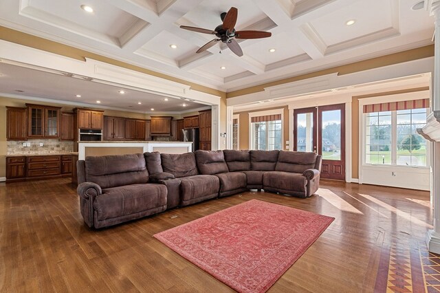 living room featuring dark wood-style flooring, ornamental molding, coffered ceiling, and beam ceiling