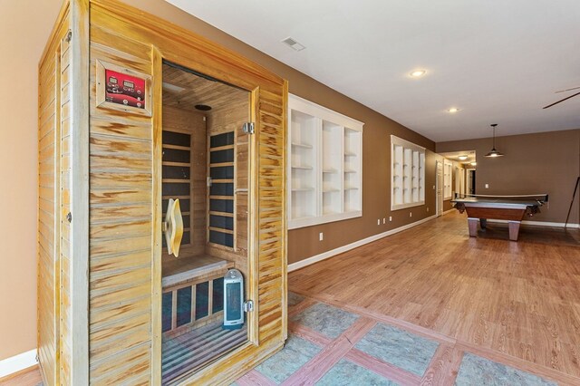 recreation room with built in shelves, pool table, wood finished floors, baseboards, and a sauna