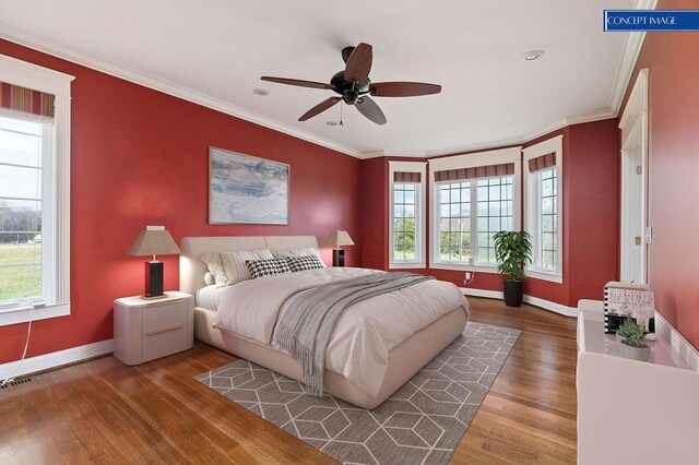 bedroom featuring multiple windows, crown molding, and wood finished floors