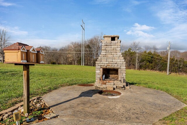 view of patio featuring an outdoor stone fireplace