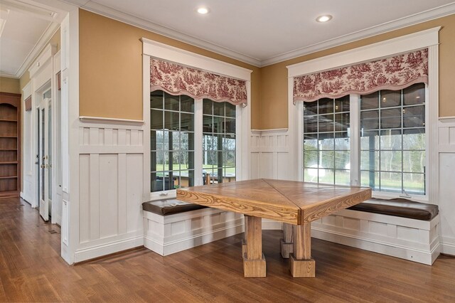 unfurnished dining area featuring recessed lighting, a wainscoted wall, wood finished floors, ornamental molding, and breakfast area