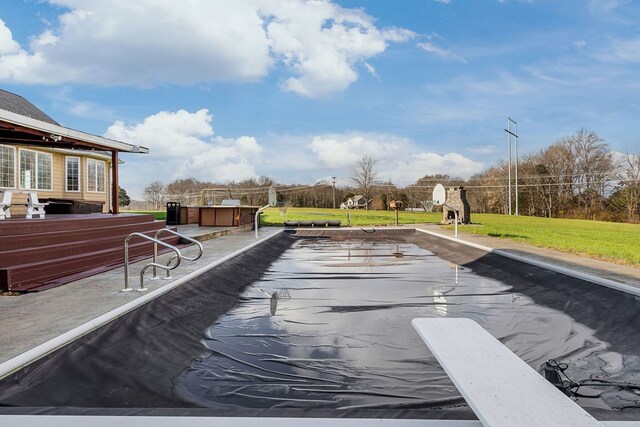 view of pool featuring a lawn