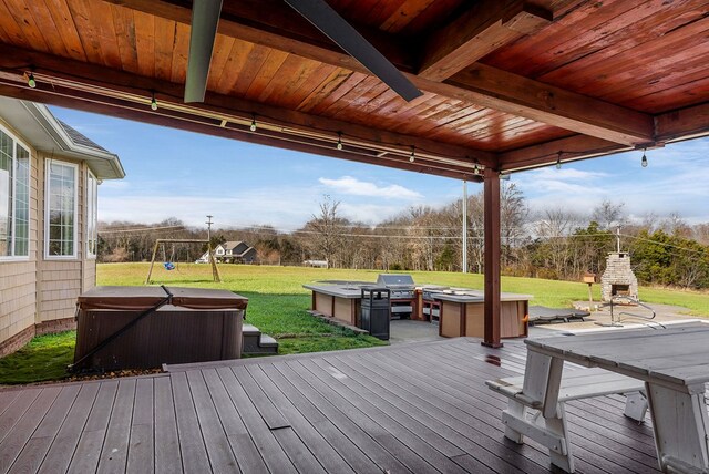 deck with a grill, a playground, a yard, and a hot tub