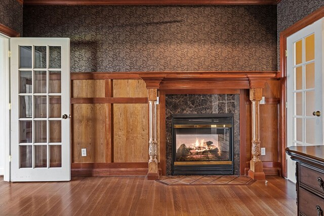 interior details with a premium fireplace and wood finished floors