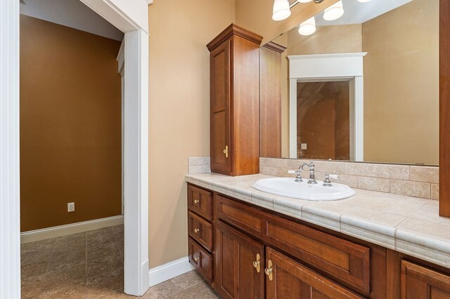 bathroom featuring baseboards and vanity