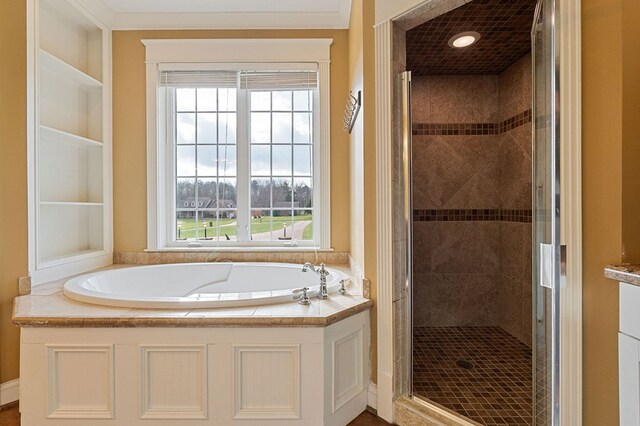 full bathroom featuring a shower stall and a bath