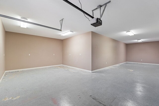 garage featuring baseboards and a garage door opener