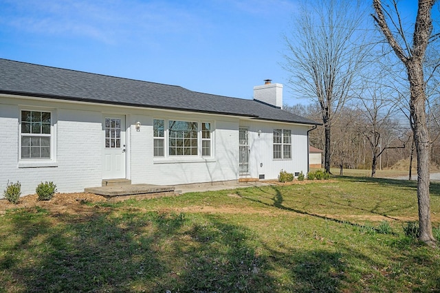 single story home featuring brick siding, a chimney, a front lawn, and roof with shingles