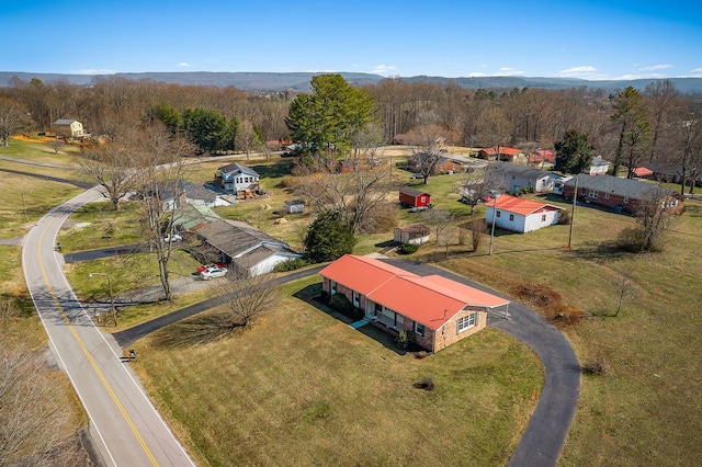 aerial view featuring a rural view and a wooded view