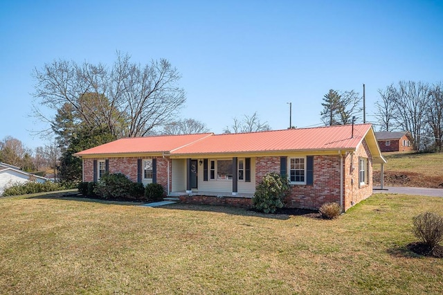 single story home with metal roof, brick siding, and a front lawn